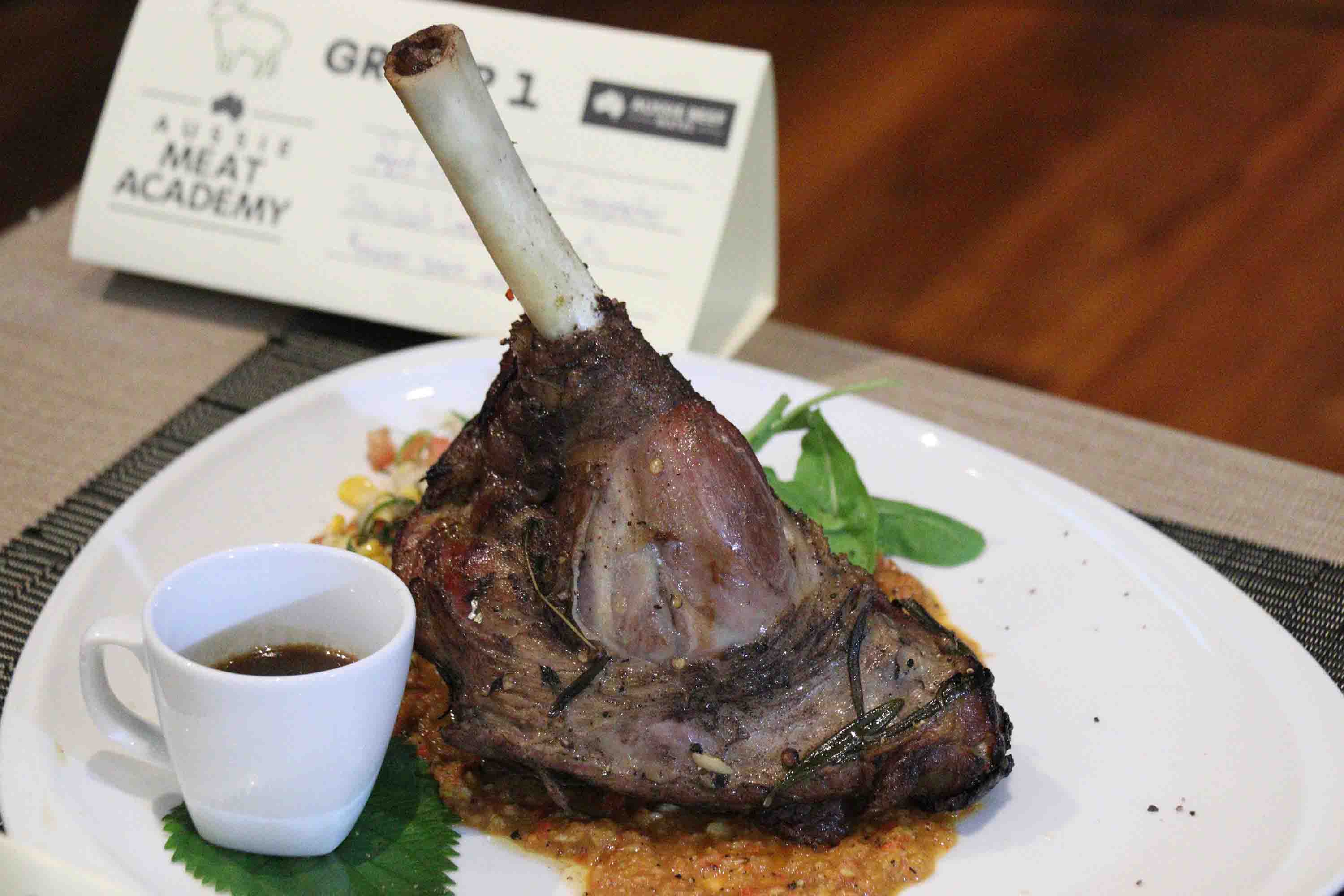 Slow-cooked lamb shanks with Romesco sauce and corn salsa